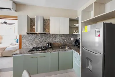 a kitchen with a refrigerator and a sink at 404 y 504 Luxurious PH with Jacuzzi near the Beach in La Laguna
