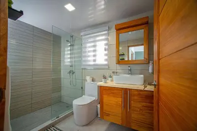 a bathroom with a shower and a toilet and a sink at 0052-Brand new oceanfront condo in Cabarete in Eslabón