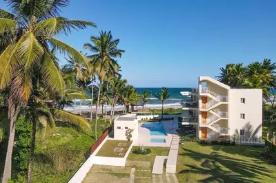 an aerial view of a resort with palm trees and the ocean at 0052-Brand new oceanfront condo in Cabarete in Eslabón