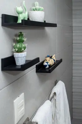 a bathroom with black shelves with a doll and a plant at 0052-Brand new oceanfront condo in Cabarete in Eslabón