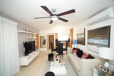 a living room with a couch and a ceiling fan at 0052-Brand new oceanfront condo in Cabarete in Eslabón