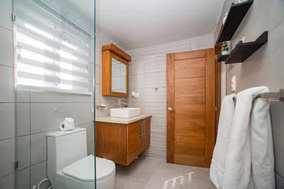 a bathroom with a toilet and a sink at 0052-Brand new oceanfront condo in Cabarete in Eslabón