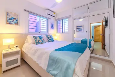 a bedroom with a large bed and a window at Oasis cerca del mar #2 in Monte Adentro