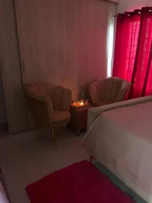 a bedroom with two chairs and a table and a bed at habitat 1 t4 101 ciudad juan Bosch in San Isidro