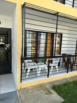 a screened in porch with two benches on a house at habitat 1 t4 101 ciudad juan Bosch in San Isidro
