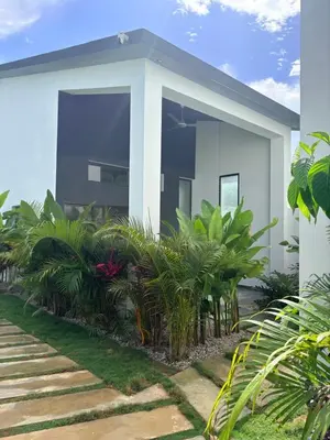 a white house with plants in front of it at Taina village in Las Terrenas