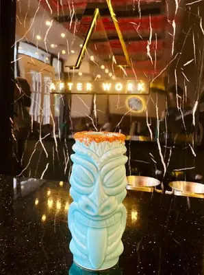 a blue and white vase on a table with lights at Heyday Studio With Full Kitchenette in Santiago de los Caballeros