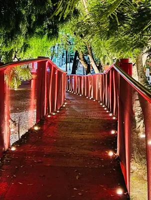 a red bridge with lights on top of it at Heyday Studio With Full Kitchenette in Santiago de los Caballeros