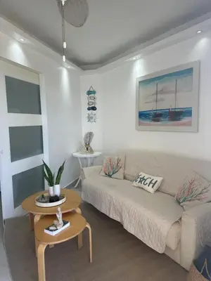 a living room with a couch and a table at Apartamento lll Vista al Mar Albatros by ju Juan Dolio in Villas del Mar