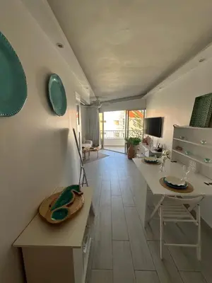 a living room with a table and chairs and a kitchen at Apartamento lll Vista al Mar Albatros by ju Juan Dolio in Villas del Mar