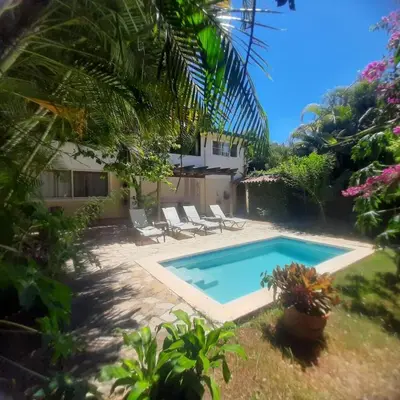 a swimming pool in the backyard of a house at Beautiful, fresh peaceful Villa in Sosúa