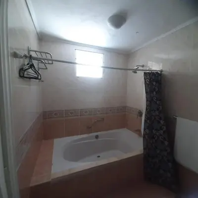 a bathroom with a bath tub with a window at Beautiful, fresh peaceful Villa in Sosúa