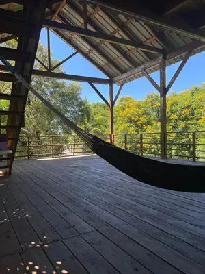 a hammock in a pavilion on a wooden deck at Beautiful, fresh peaceful Villa in Sosúa