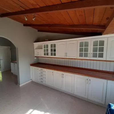 a kitchen with white cabinets and a wooden ceiling at Beautiful, fresh peaceful Villa in Sosúa