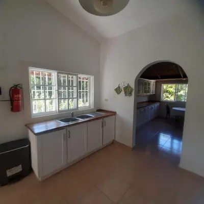 a kitchen with a sink and an archway in it at Beautiful, fresh peaceful Villa in Sosúa