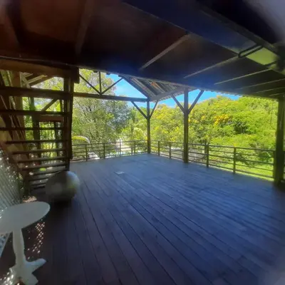 a large deck with a view of the woods at Beautiful, fresh peaceful Villa in Sosúa