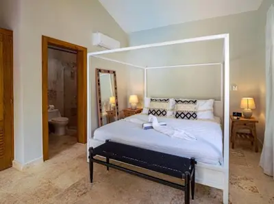a bedroom with a large white bed with a canopy at Modern 6 Br Villa With Hot Tub in Sosúa