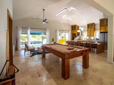 a large living room with a pool table in it at Modern 6 Br Villa With Hot Tub in Sosúa