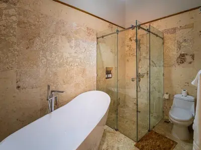 a bathroom with a bath tub and a toilet at Modern 6 Br Villa With Hot Tub in Sosúa