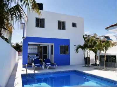 a blue and white house with a swimming pool at pavilus in Punta Cana