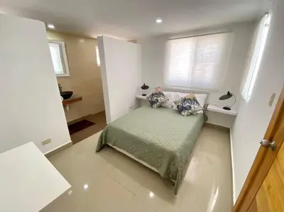 a small bedroom with a bed in a room at pavilus in Punta Cana