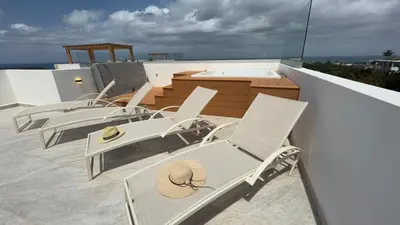 a group of chairs sitting on top of a roof at Oceanview Villa With King Beds in Las Terrenas