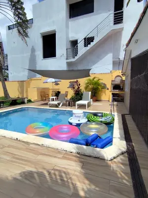 a swimming pool with four frisbees on it at Cruce Caribeña in Boca Chica