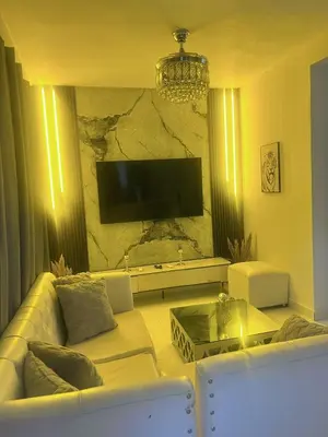 a living room with a white couch and a tv at Casa amueblada en San Cristóbal in San Cristóbal