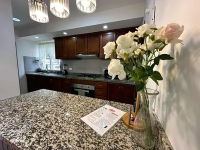 a kitchen with a vase of flowers on a counter at Casa en la Autopista de San Isidro in Hainamosa