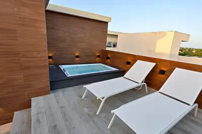 two white chairs and a hot tub on a balcony at 504 New, Fantastic Rooftop with Private Jacuzzi in La Laguna