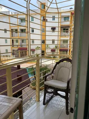 a chair on a balcony with a view of a building at Brisa de mar BOCA CHICA, in Boca Chica