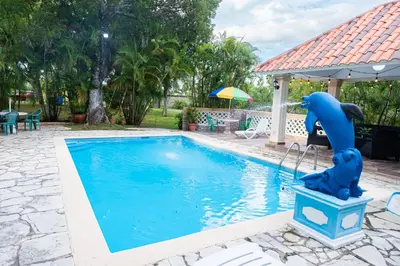 a pool with a dolphin fountain in a yard at Rancho Juliana in Villas del Mar