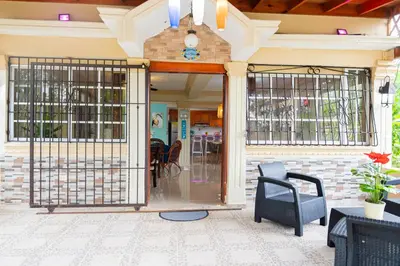 a front door of a building with a blue chair at Rancho Juliana in Villas del Mar