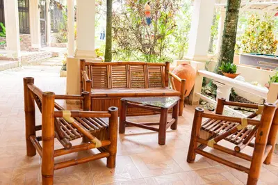 a group of chairs and a table on a porch at Rancho Juliana in Villas del Mar