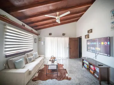 a living room with a couch and a flat screen tv at 2BR Colonial Penthouse in Sosua next to BEACH in Sosúa