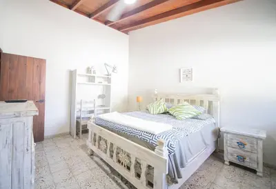 a bedroom with a bed in a white room at 2BR Colonial Penthouse in Sosua next to BEACH in Sosúa