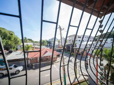 a view of a city street from a window at 2BR Colonial Penthouse in Sosua next to BEACH in Sosúa