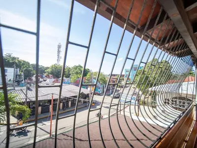 a view of a street from a building through a window at 2BR Colonial Penthouse in Sosua next to BEACH in Sosúa