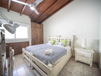 a bedroom with a bed and a lamp and a window at 2BR Colonial Penthouse in Sosua next to BEACH in Sosúa