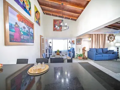 a living room with a blue couch and a table at Colonial 2BR Apartment 2mins walk to beach in Sosúa