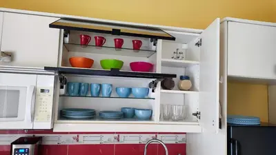 a kitchen cabinet with bowls and plates in it at Caribe Home Dominicus Ginepro 3 in La Laguna