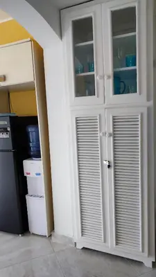 a white cabinet with glass doors in a kitchen at Caribe Home Dominicus Ginepro 3 in La Laguna