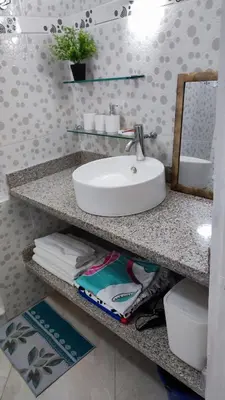 a bathroom counter with a sink and a mirror at Caribe Home Dominicus Ginepro 3 in La Laguna