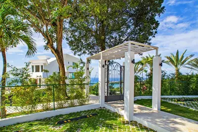 a gate to a villa with palm trees at 5 mins from beach, Hilltop villa with pool in La Pared