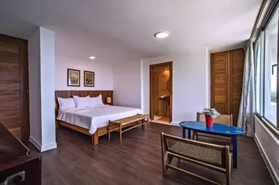 a bedroom with a bed and a blue table at 5 mins from beach, Hilltop villa with pool in La Pared
