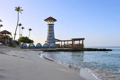 a lighthouse on a beach next to the ocean at 404-C Luxurious Apartment 5 Minutes from the Beach in La Laguna