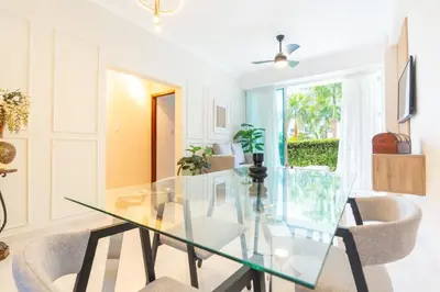 a dining room with a glass table and chairs at Beach Escape -Pool Patio -Free Parking -Pets in Villas del Mar
