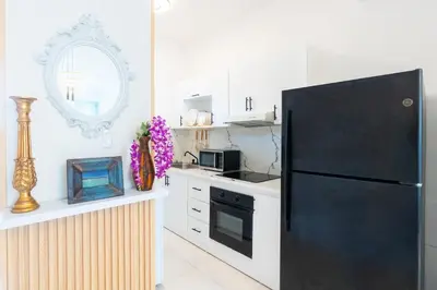 a kitchen with a black refrigerator and a counter at Beach Escape -Pool Patio -Free Parking -Pets in Villas del Mar