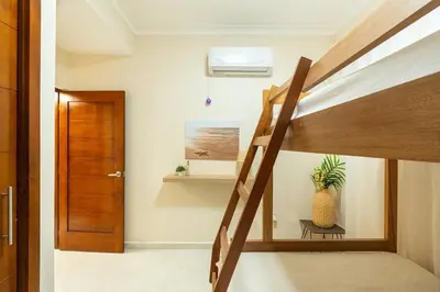 a room with a bunk bed with a staircase and a door at Beach Escape -Pool Patio -Free Parking -Pets in Villas del Mar