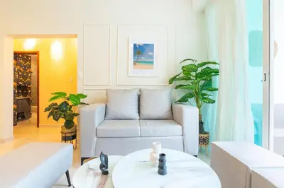 a living room with a couch and a table at Beach Escape -Pool Patio -Free Parking -Pets in Villas del Mar